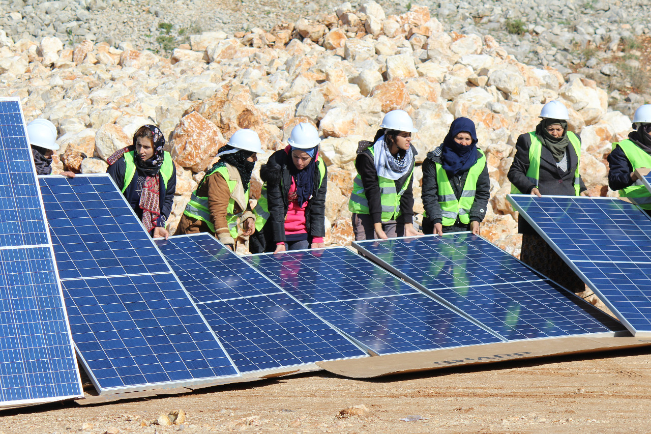 A group installing solar panels.