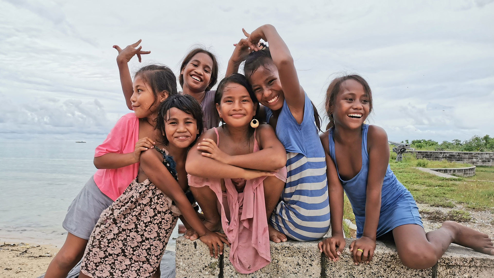 Girls standing on a sea-wall built from plastic bags to prevent flooding in South Tarawa, Kiribati. 29 January 2020.