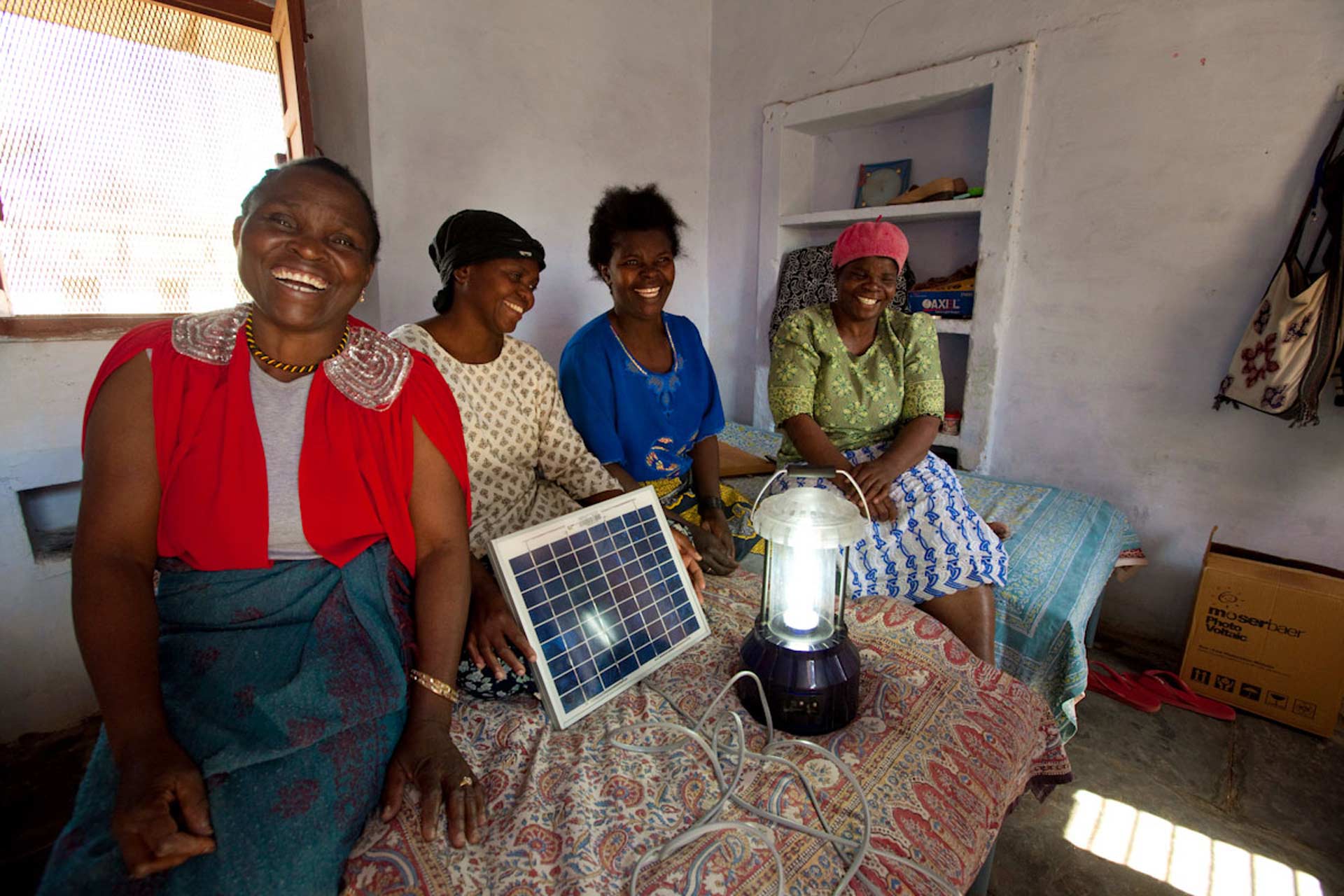 Women travel across Africa to take part in a six-month training programme to become solar engineers. The photo above shows graduates from Liberia and Malawi.