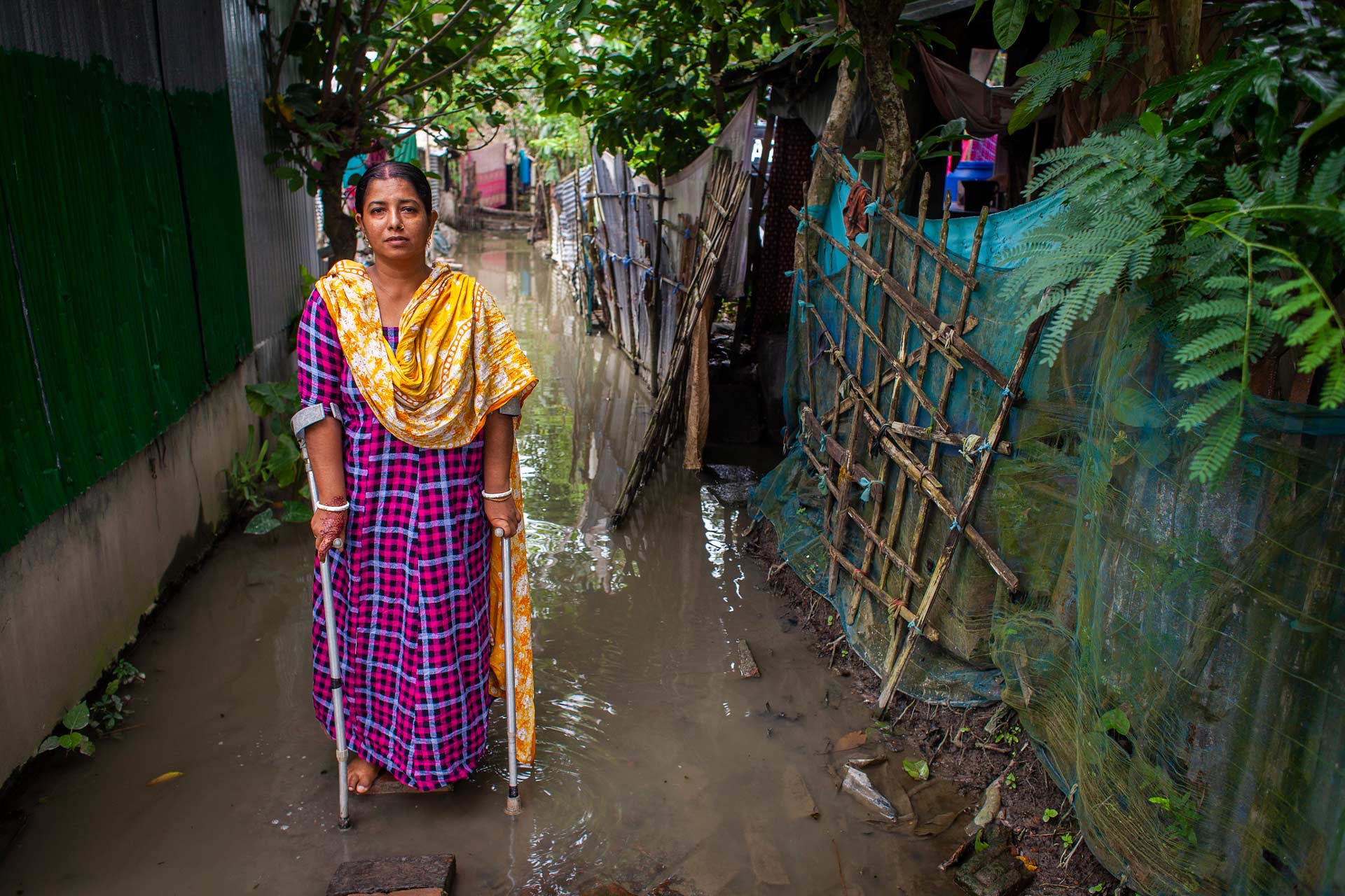 Woman using crutches after a flood in Bangladesh