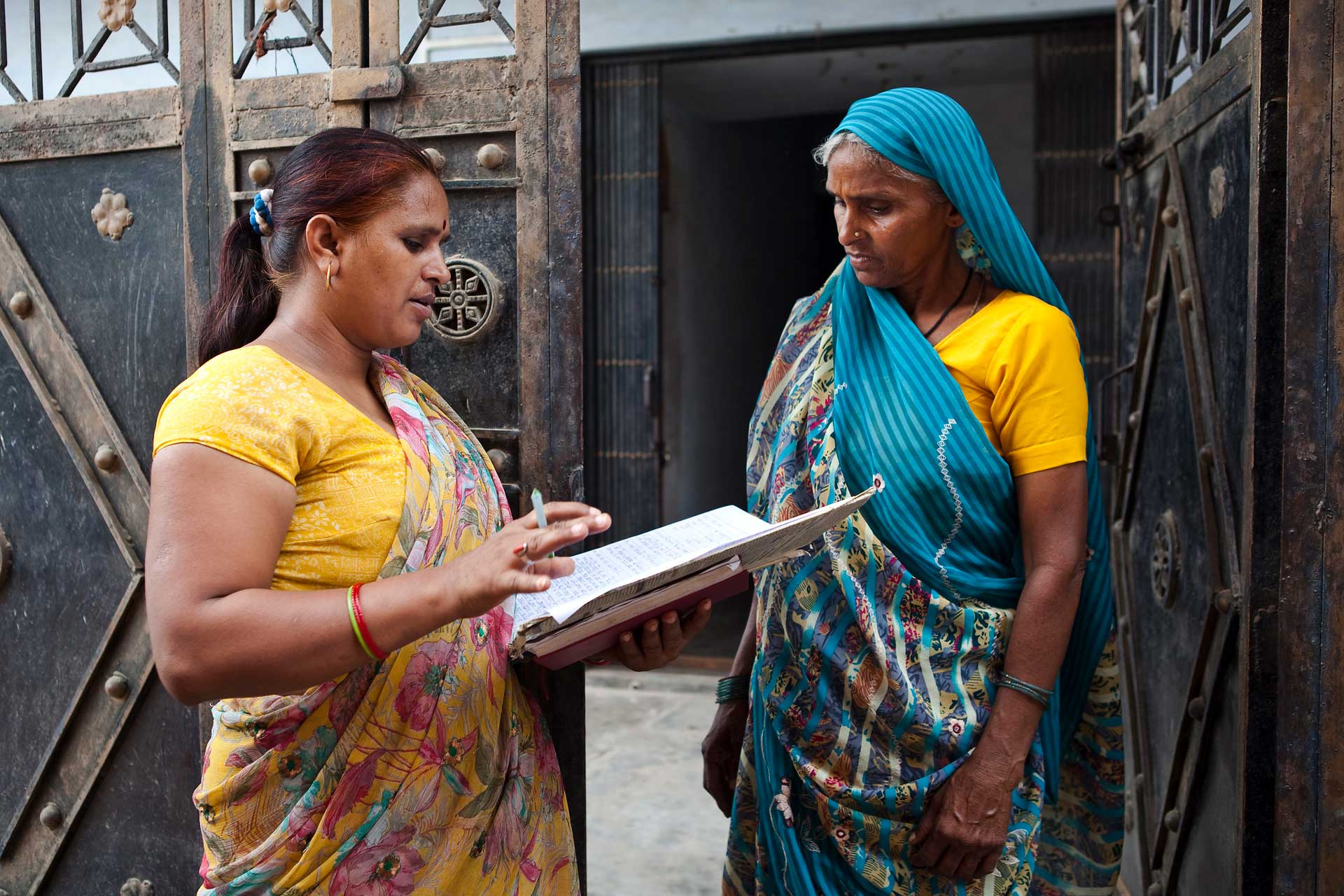 Savita Sharma informs a widow on her right to receive a pension in Vrindavan, India.