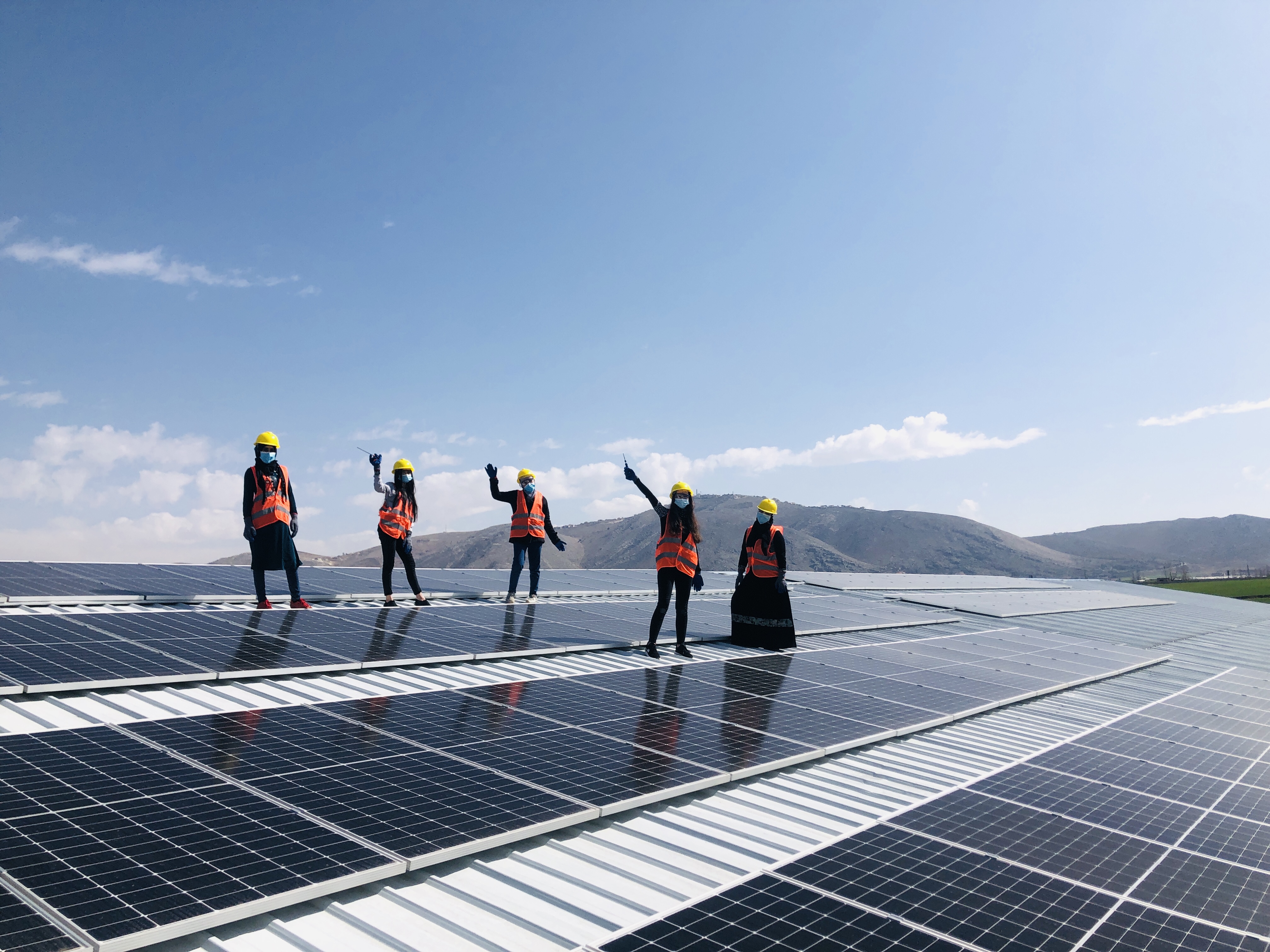 group of women working on a solar panel