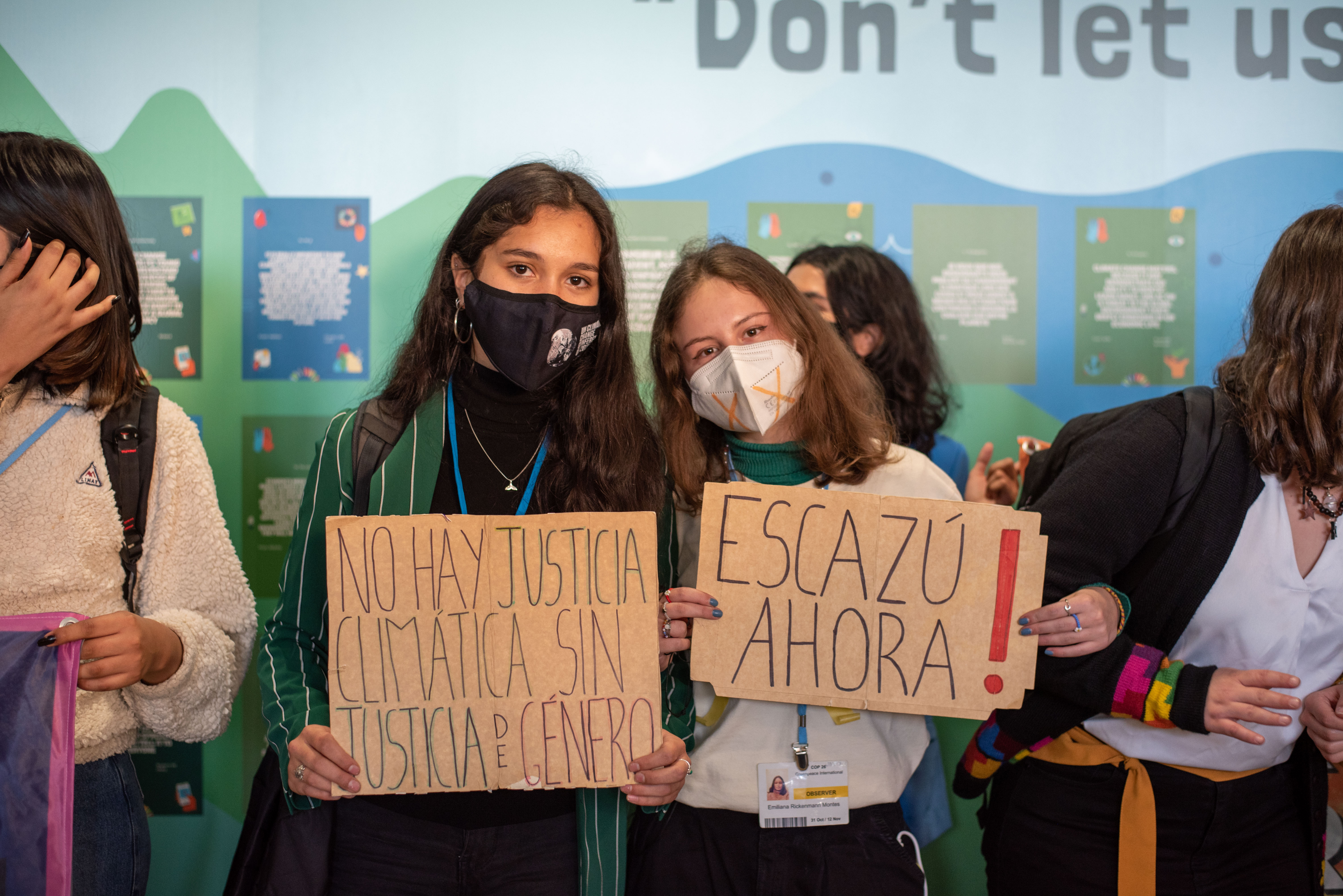 Catalina Santelices (Chile) and Emiliana Rickenmann (Colombia) with signs at a demonstration for Escazú