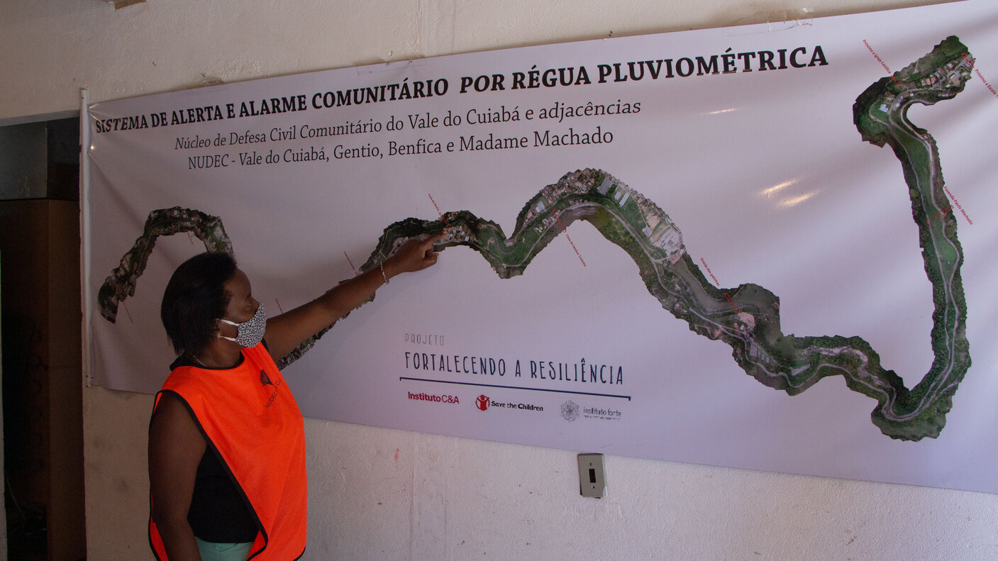 Woman pointing at a map of a river. 