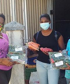 Women showing packaged vegetables