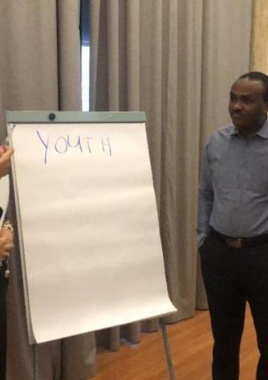 Four people presenting on youth