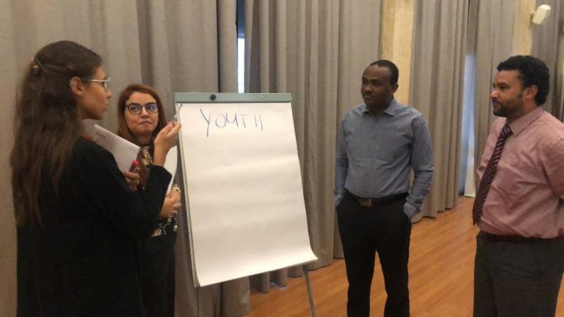Four people presenting on youth