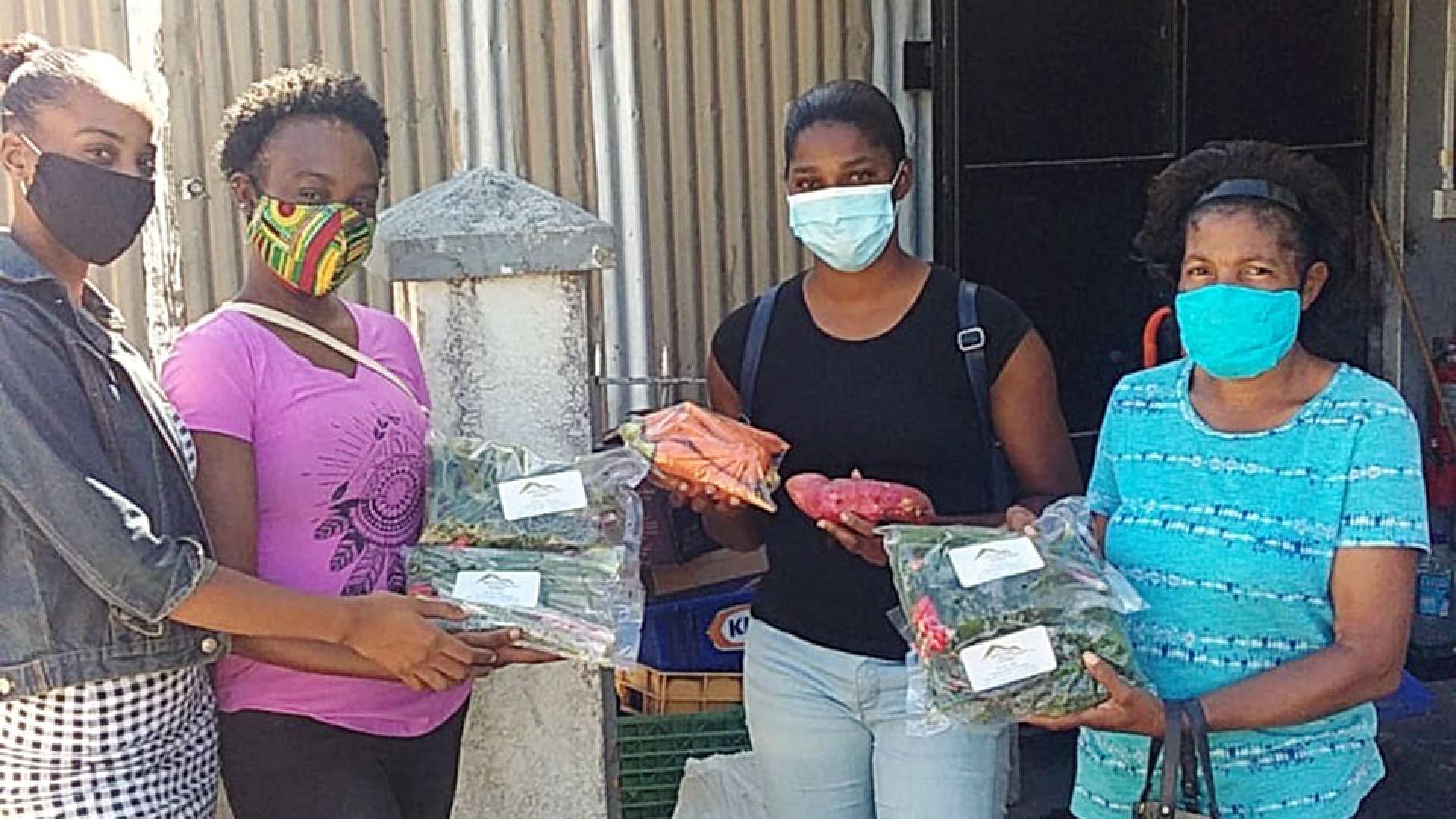 Women showing packaged vegetables