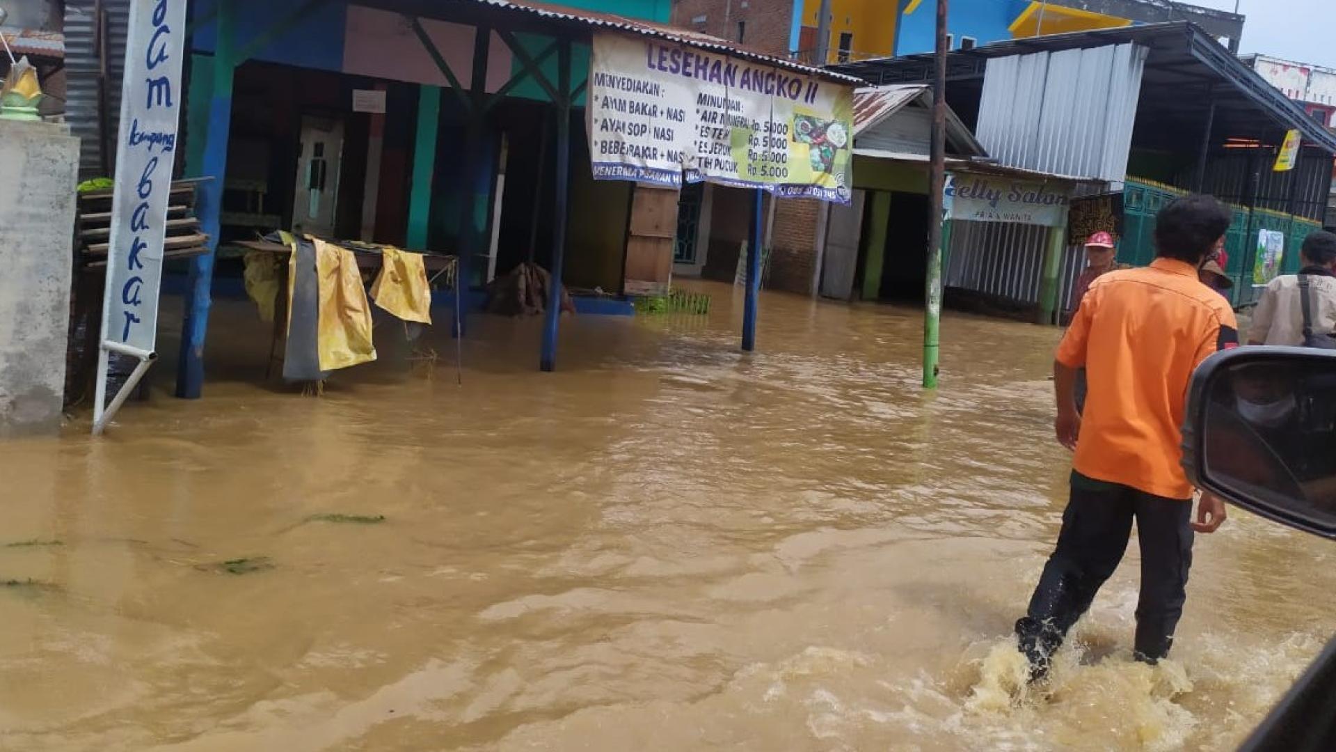 Man walking through flooded street