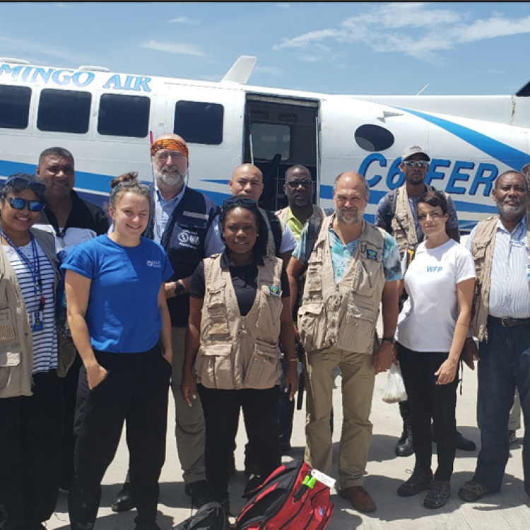People starting in front of a small plane