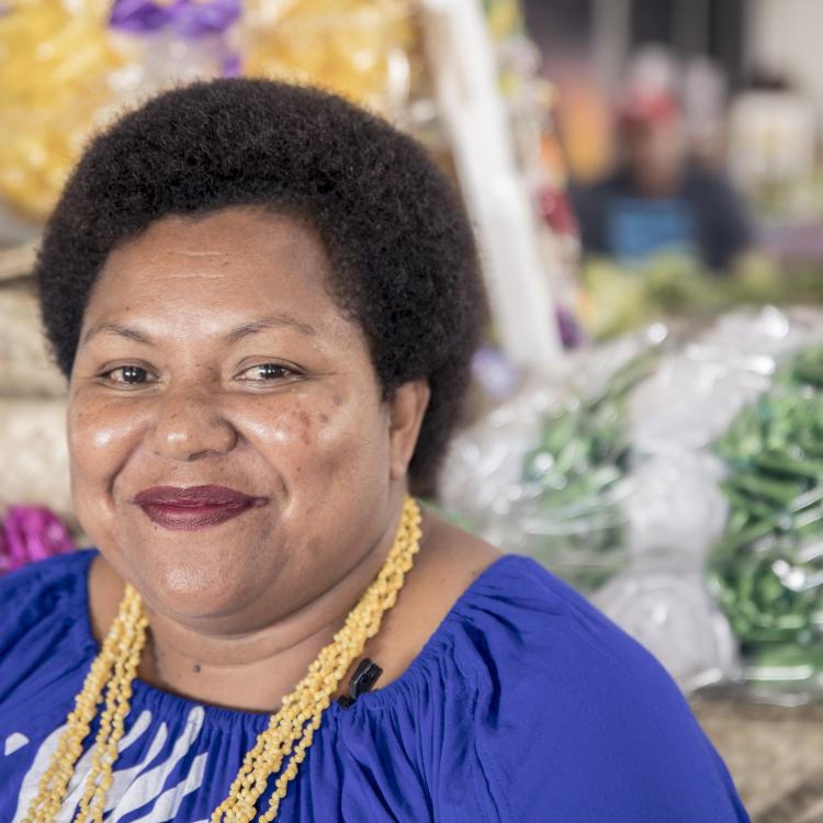 Woman in front of her market stall