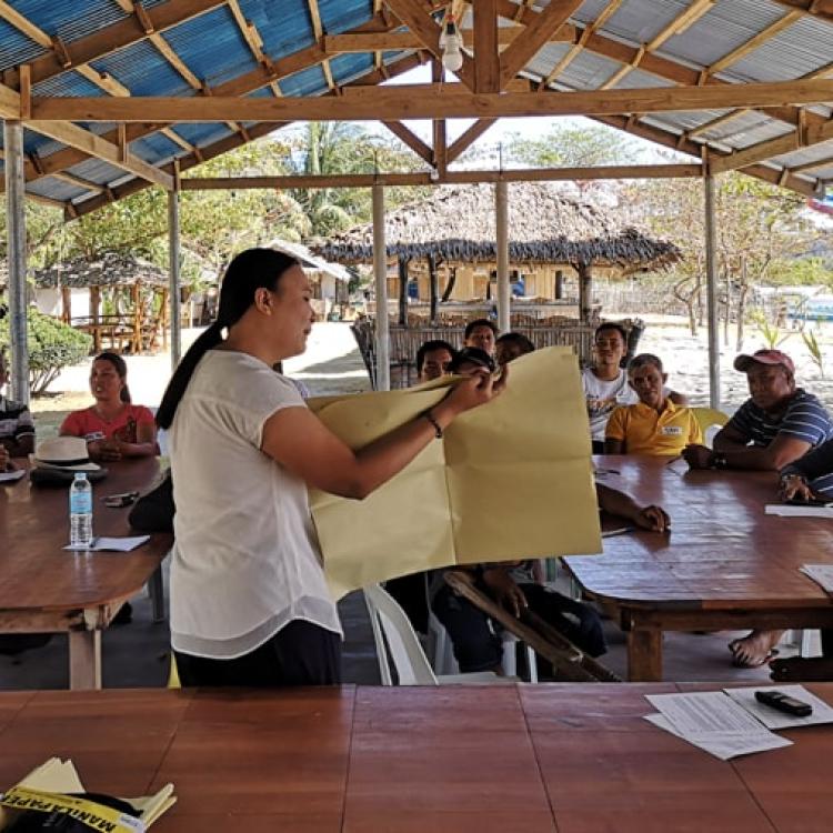 Women showing a map to a group of people
